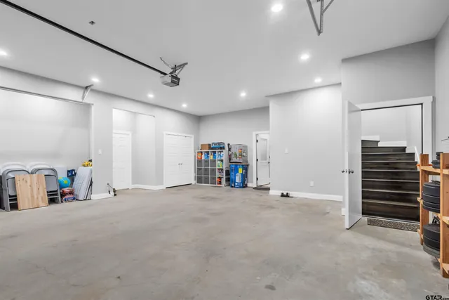 a view of an empty room with furniture and a ceiling fan
