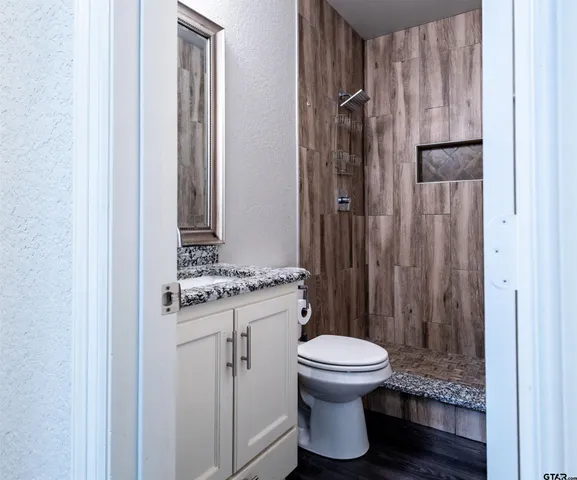 a bathroom with a toilet and a shower