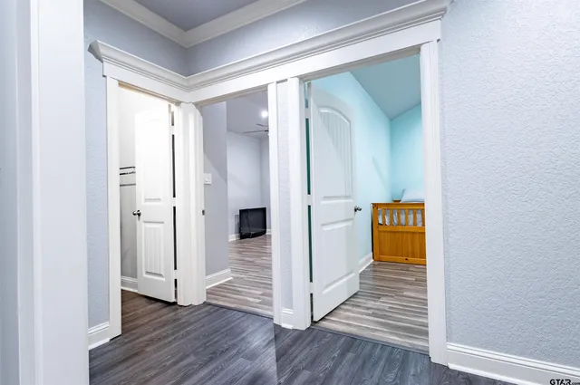 a view of a hallway with wooden floor