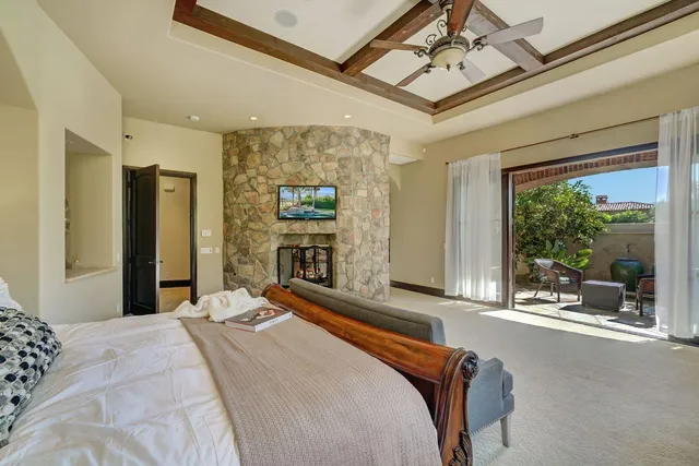 a bedroom with a bed mirror and window