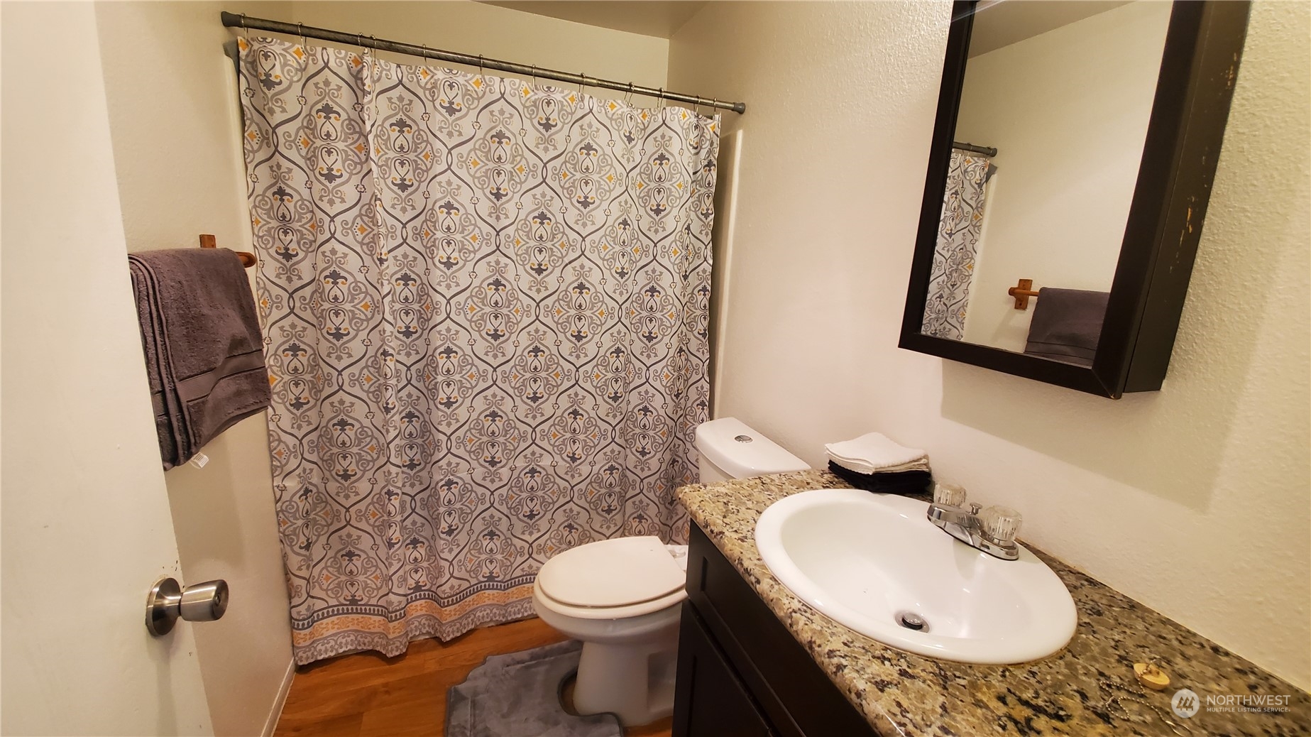 5012 South 58th Street Tacoma, WA 98409 - Photo 12 of 22 a bathroom with a toilet sink and mirror