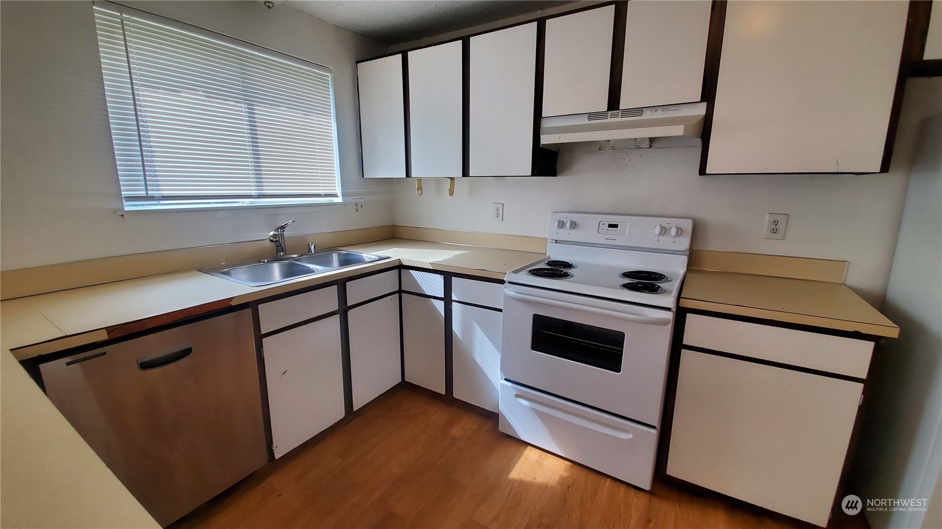 5012 South 58th Street Tacoma, WA 98409 - Photo 15 of 22 a kitchen with stainless steel appliances granite countertop white cabinets sink and stove