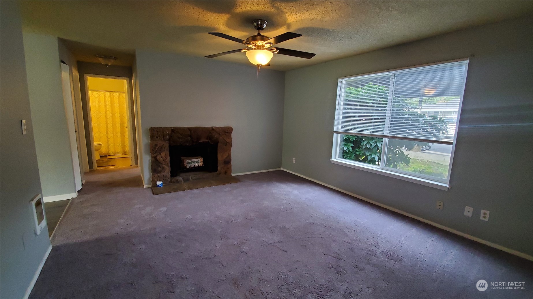 5012 South 58th Street Tacoma, WA 98409 - Photo 9 of 22 an empty room with windows and fireplace