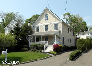 102 River Road Cos Cob, CT 06807 - Photo 1 of 14 a front view of a house with a garden and plants