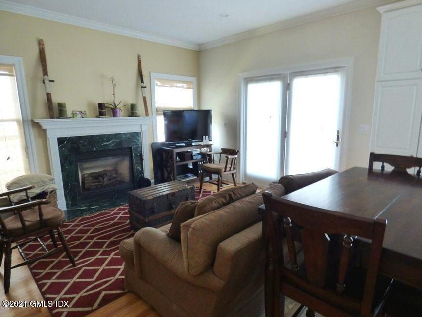 102 River Road Cos Cob, CT 06807 - Photo 6 of 14 a living room with furniture a flat screen tv and a fireplace