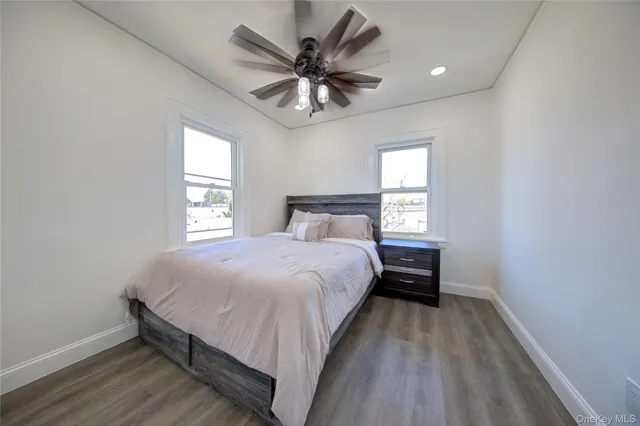 a bedroom with a bed and a large window