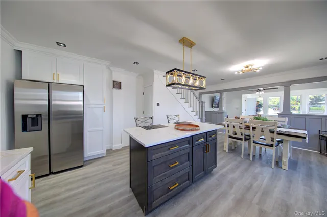 a kitchen with a table chairs and wooden floor