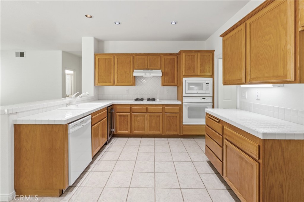 2311 Gillingham Circle Thousand Oaks, CA 91362 - Photo 11 of 71 a kitchen with a stove sink and cabinets