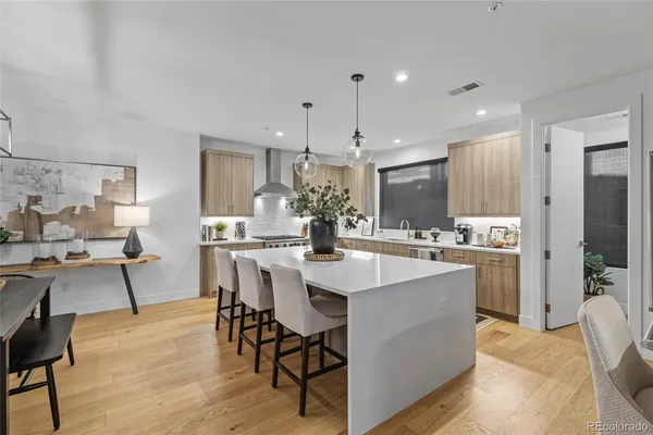 a kitchen with stainless steel appliances kitchen island granite countertop a sink and cabinets