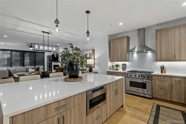 a kitchen with stainless steel appliances granite countertop a stove and a white cabinets