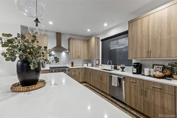 a kitchen with kitchen island granite countertop a sink stainless steel appliances and cabinets