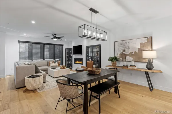a view of a dining room with furniture wooden floor and chandelier