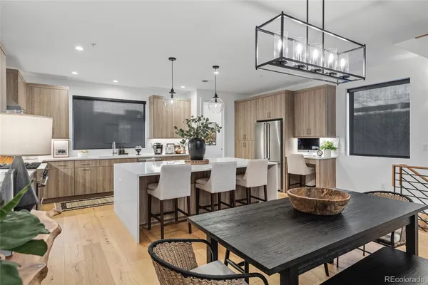 a kitchen with a table chairs and a chandelier