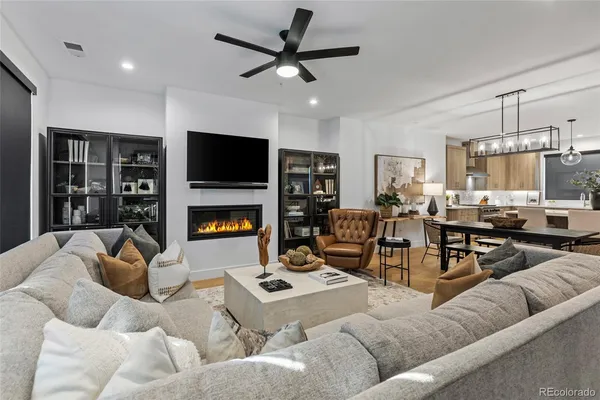 a living room with furniture kitchen view and a fireplace