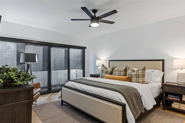 a bedroom with bed and a potted plant