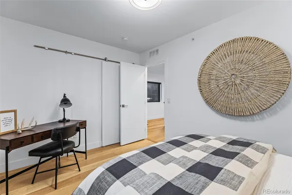 a bedroom with a bed and a table in it