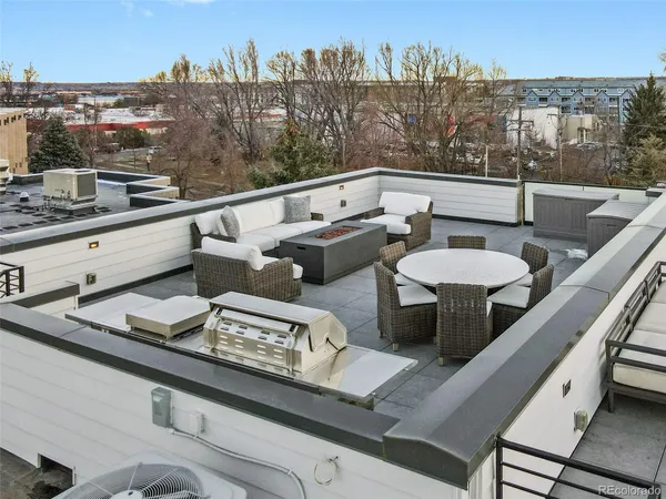 a view of a balcony with couches and a potted plant on a table