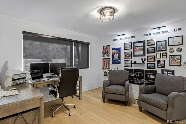 a view of a livingroom with workspace and a couch