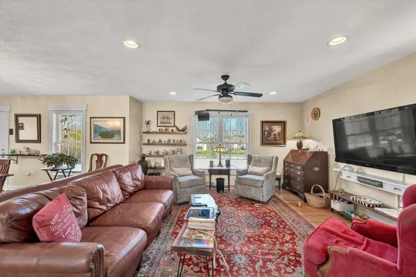 a kitchen with stainless steel appliances granite countertop a refrigerator a sink dishwasher a stove with wooden cabinets and floor