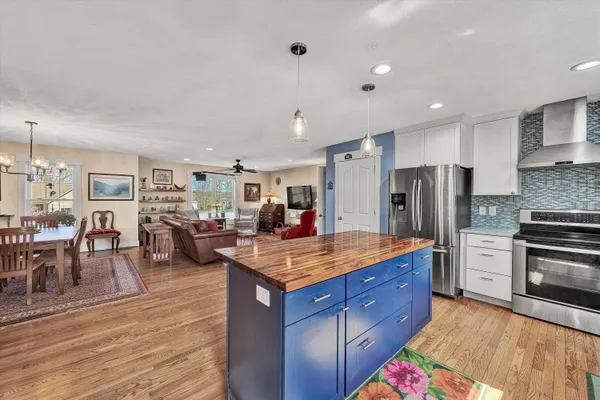 a kitchen with granite countertop a sink stainless steel appliances and cabinets