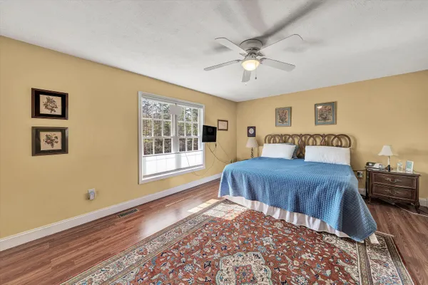 a bedroom with furniture window and wooden floor
