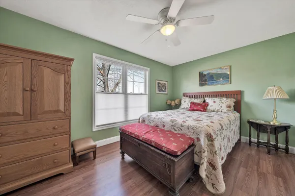 a roof deck with couches and wooden fence