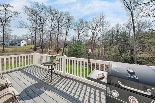 a view of a chair and tables in the balcony