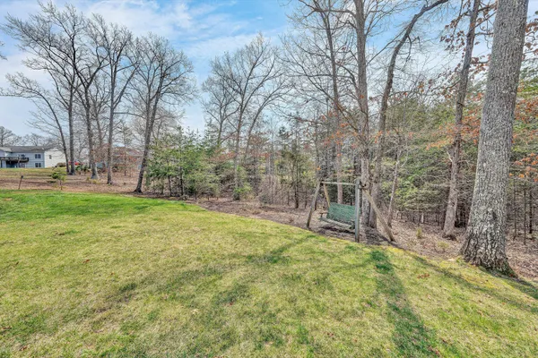a view of a house with a large window and wooden fence