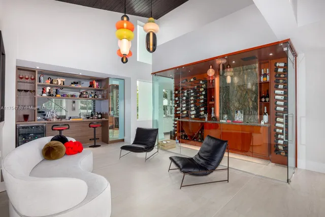 a living room with patio furniture and a floor to ceiling window
