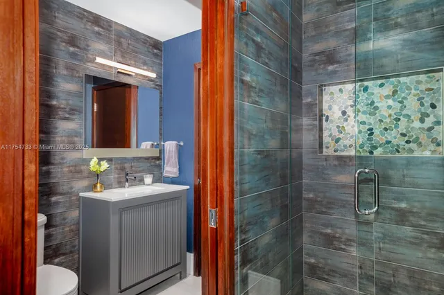 a bathroom with a sink toilet and shower