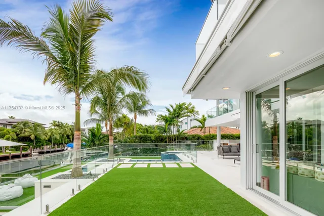a view of a swimming pool with a garden and patio