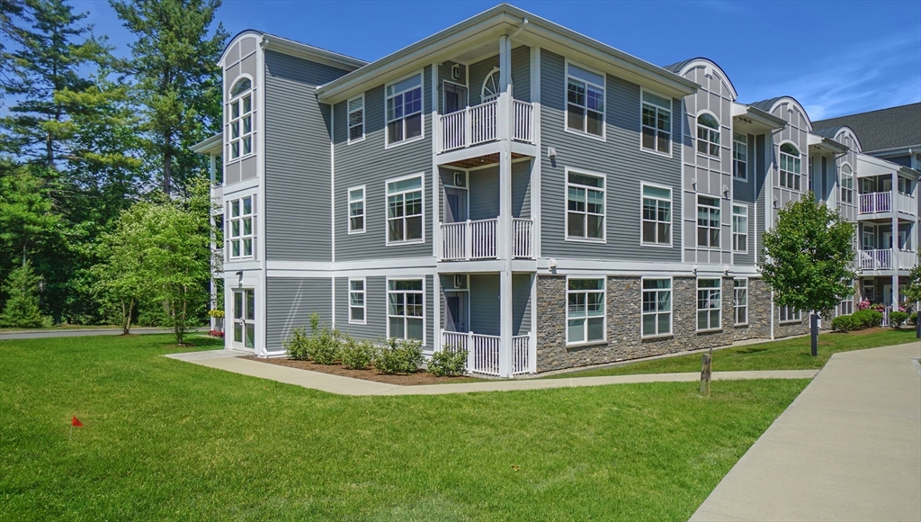a front view of a building with a yard