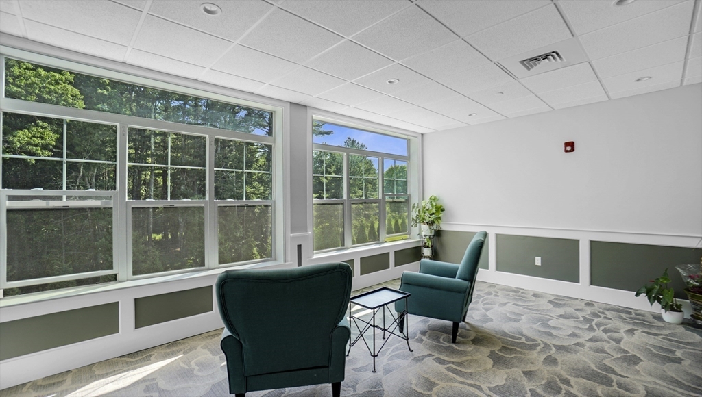 635 Old Post Road, Unit 204 Sharon, MA 02067 - Photo 16 of 22 a living room with furniture and a large window
