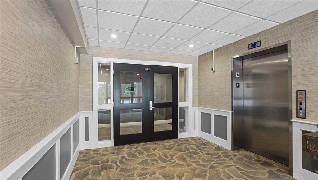 635 Old Post Road, Unit 204 Sharon, MA 02067 - Photo 17 of 22 a view of hallway with a large window