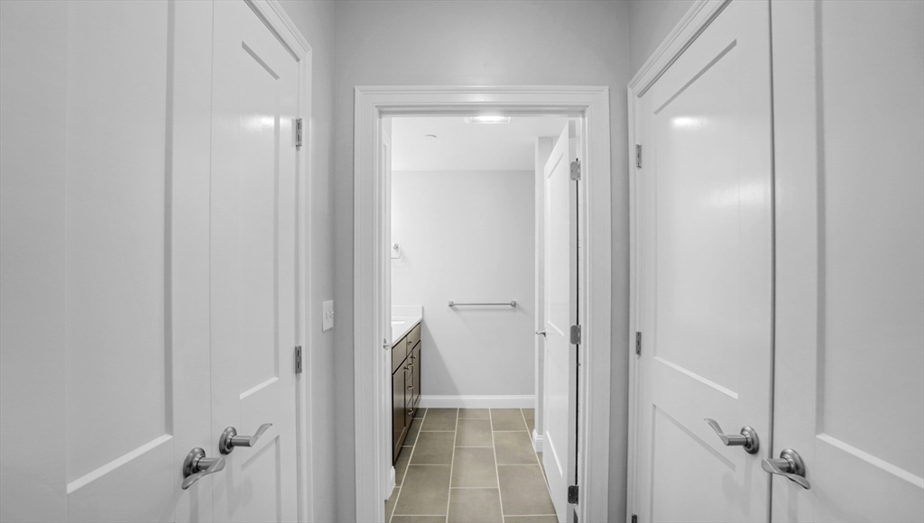 635 Old Post Road, Unit 204 Sharon, MA 02067 - Photo 7 of 22 a bathroom with a glass shower door and a sink