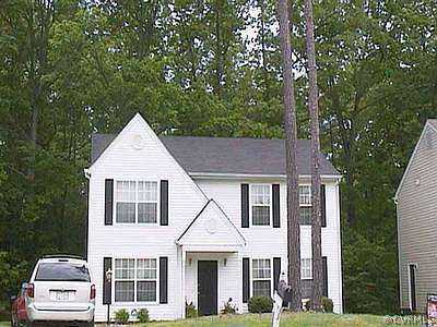 a view of a white house next to a yard with large trees