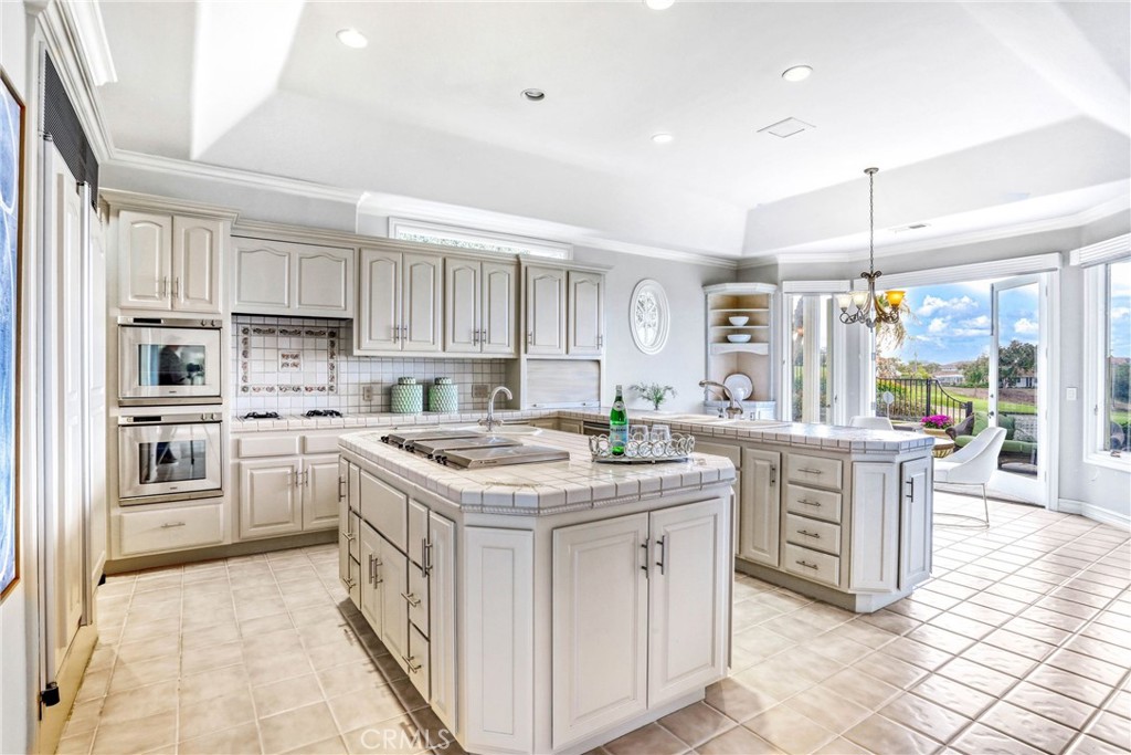 39 Marbella Dana Point, CA 92629 - Photo 14 of 58 a kitchen that has a lot of white cabinets and stainless steel appliances