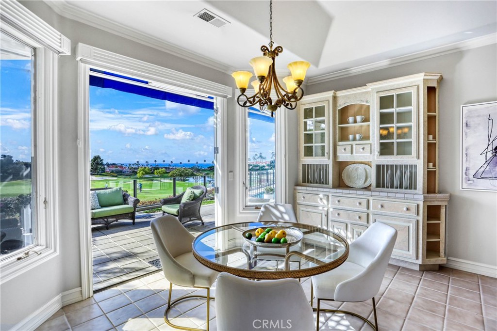 39 Marbella Dana Point, CA 92629 - Photo 18 of 58 a dining room with furniture a large window and a chandelier