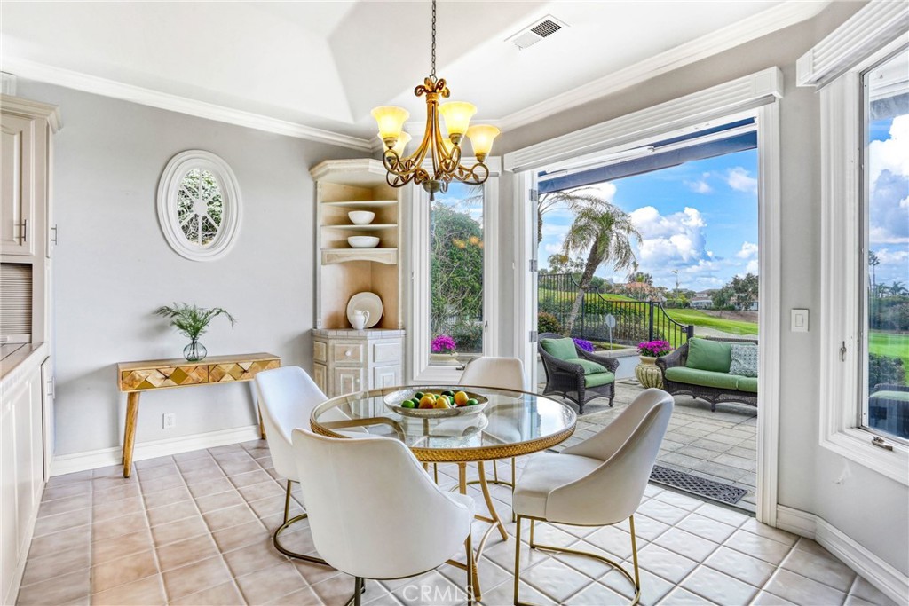 39 Marbella Dana Point, CA 92629 - Photo 19 of 58 a dining room with furniture a rug a potted plant and a chandelier