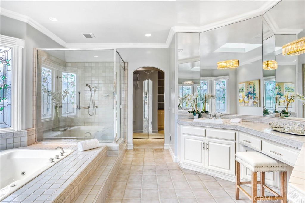 39 Marbella Dana Point, CA 92629 - Photo 26 of 58 a large bathroom with a granite countertop tub a double vanity sink and a large mirror