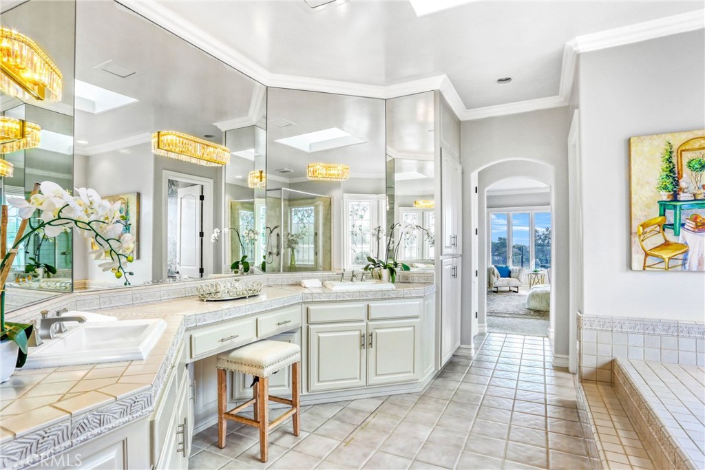 39 Marbella Dana Point, CA 92629 - Photo 27 of 58 a large bathroom with a granite countertop sink mirror and a bath tub