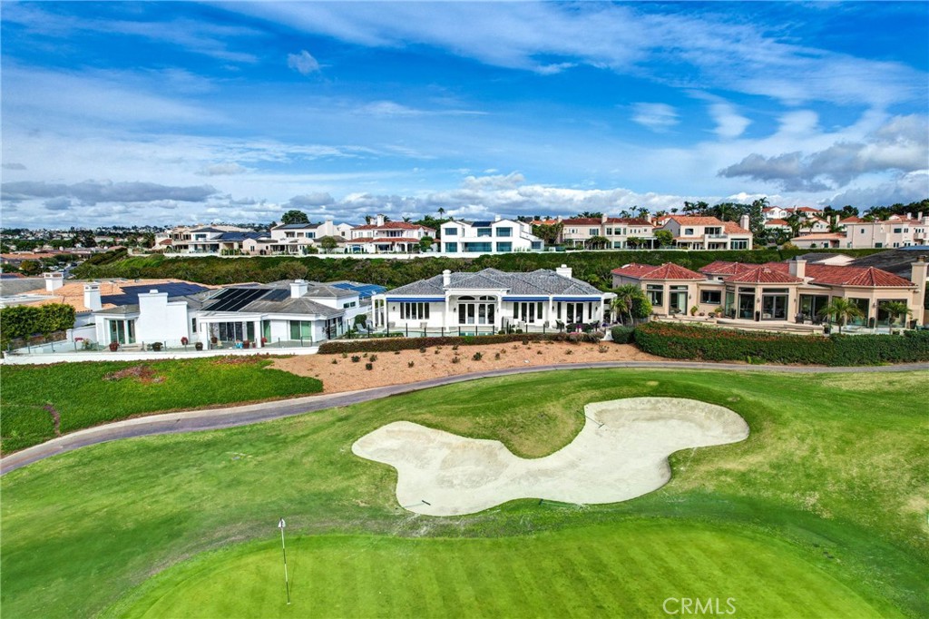 39 Marbella Dana Point, CA 92629 - Photo 46 of 58 a view of a swimming pool with lawn chairs and large trees