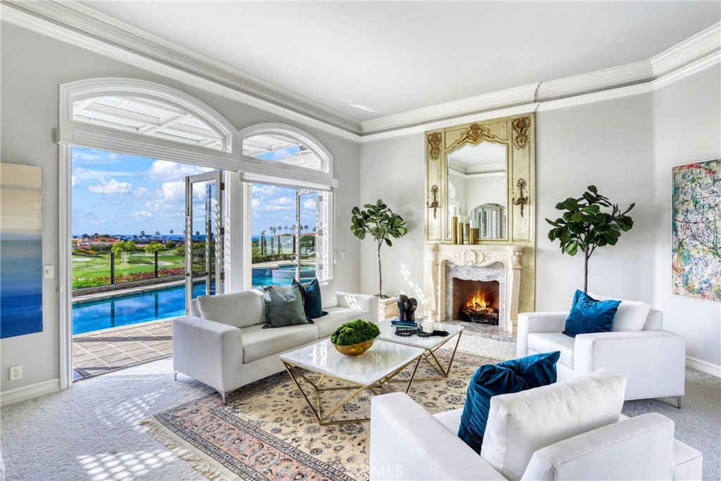 39 Marbella Dana Point, CA 92629 - Photo 9 of 58 a living room with furniture and a fireplace