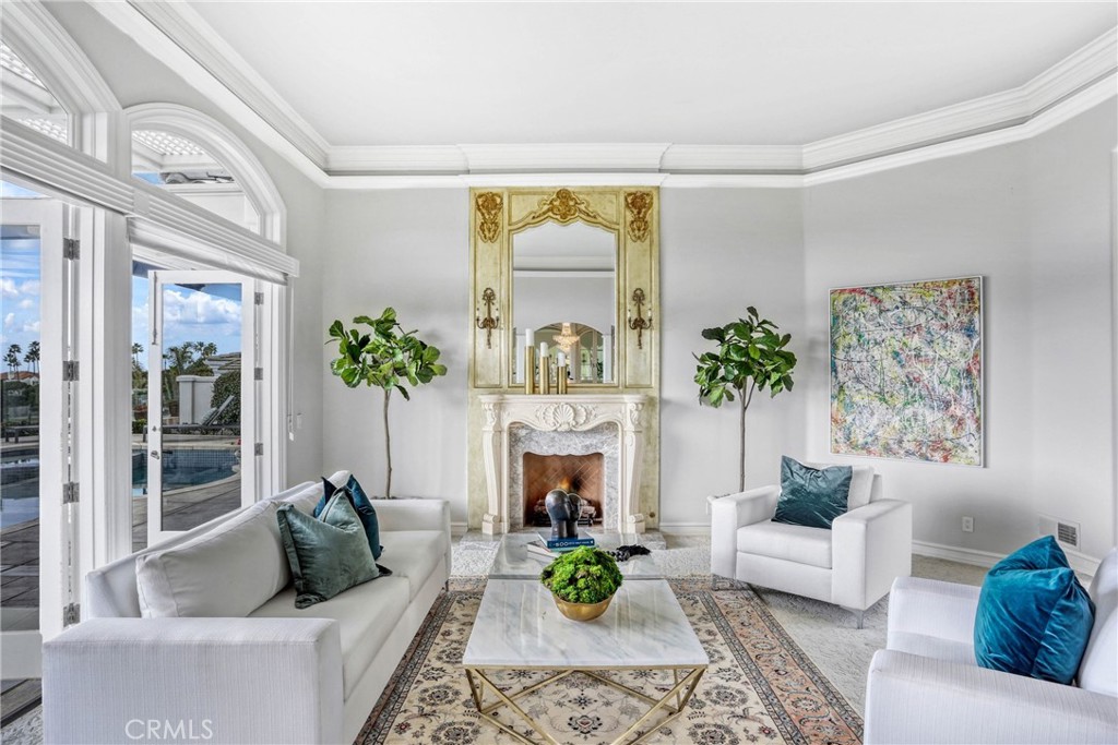 39 Marbella Dana Point, CA 92629 - Photo 10 of 58 a living room with furniture a fireplace and a potted plant