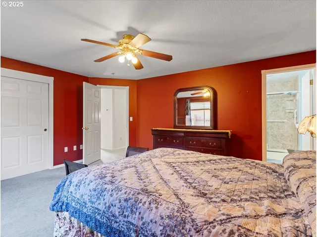 a bedroom with a large bed and a chandelier