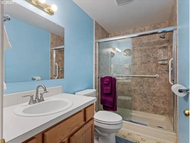 a bathroom with a sink toilet and shower
