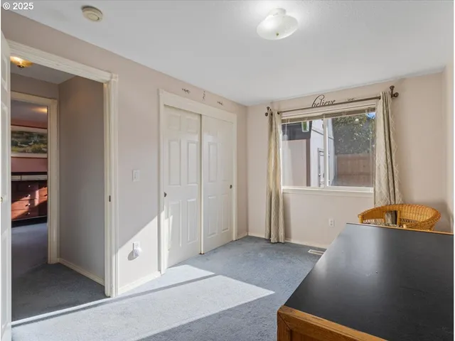 a room with a baby bed and dresser