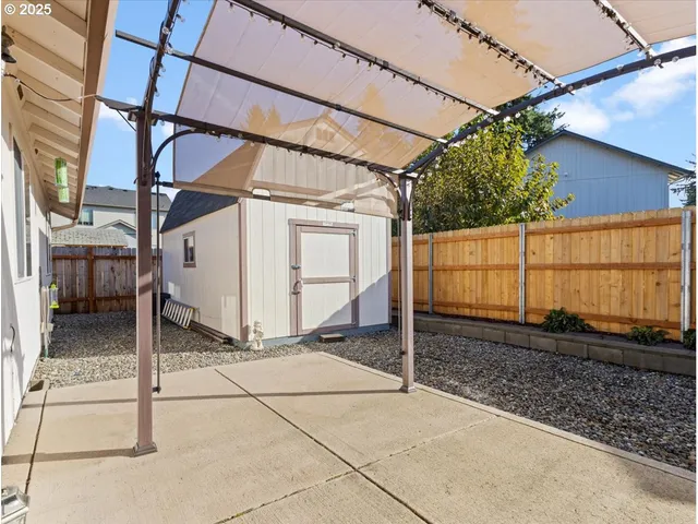 a view of a house with floor to ceiling windows and a table
