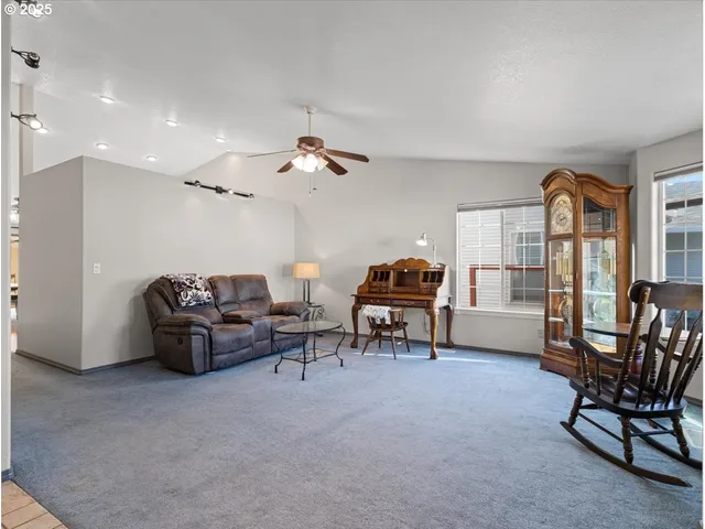 a living room with furniture a dining table and a piano table