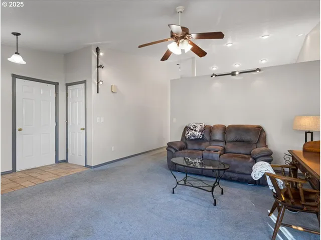 a living room with furniture and a ceiling fan